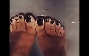 MILF films her beautiful mature black feet with sexy nail polish
