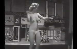 Gorgeous vintage model with big beautiful breasts dancing on stage in waxen panties