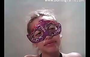 Masked pretty girl acquires a spunk rain over her face