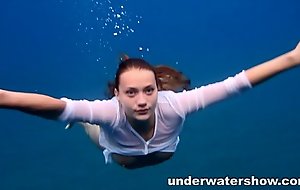 Julia swimming in nature's garb in the sea
