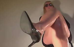Blond girl toe tapping and playing in black high heels