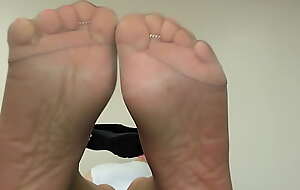 Soles tease on conference room table in reinforced toe taupe shade sheer hose
