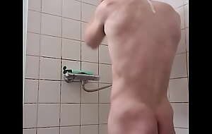 Muscle cadger adjacent to shower with cut hair