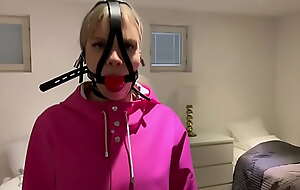 Vanessa connected with heavy rainwear and gag.
