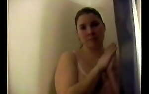 Busty Unilluminated with big unartificial tits strips in a catch shower and gets wet