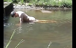 Jizzing on a stone in a river